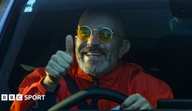 Manchester City manager Enzo Maresca gives a thumbs-up as he arrives at the City Football Academy in his car