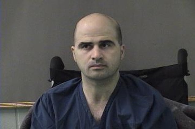 Bald man in blue prison jumpsuit