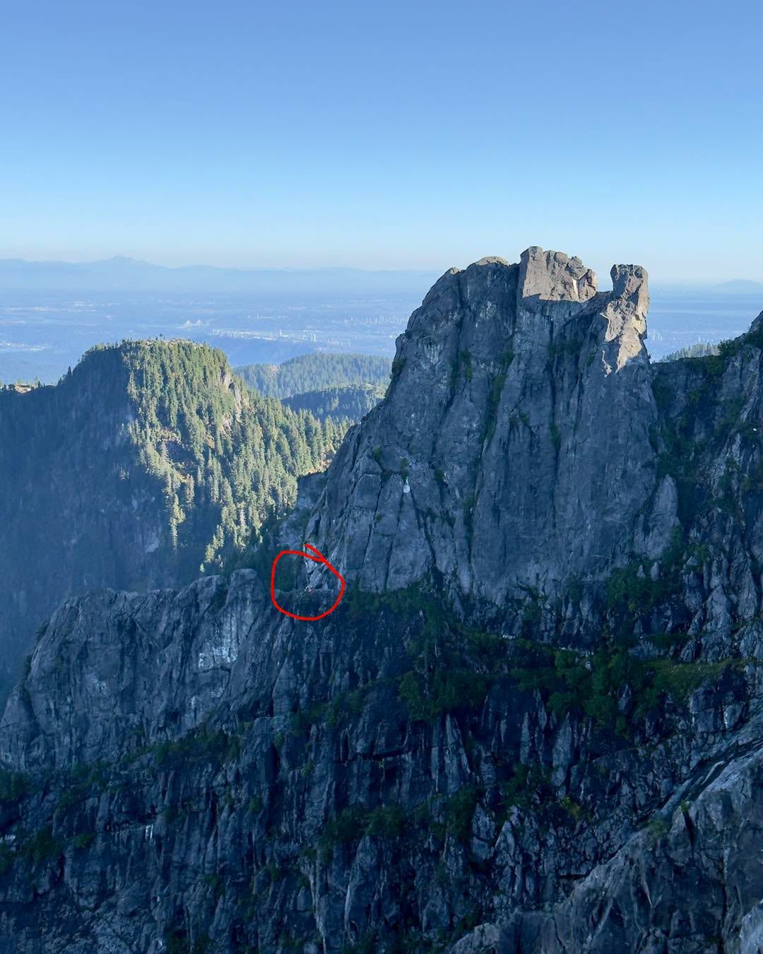 A photo of a mountain with a red circle showing where a stranded hiker is