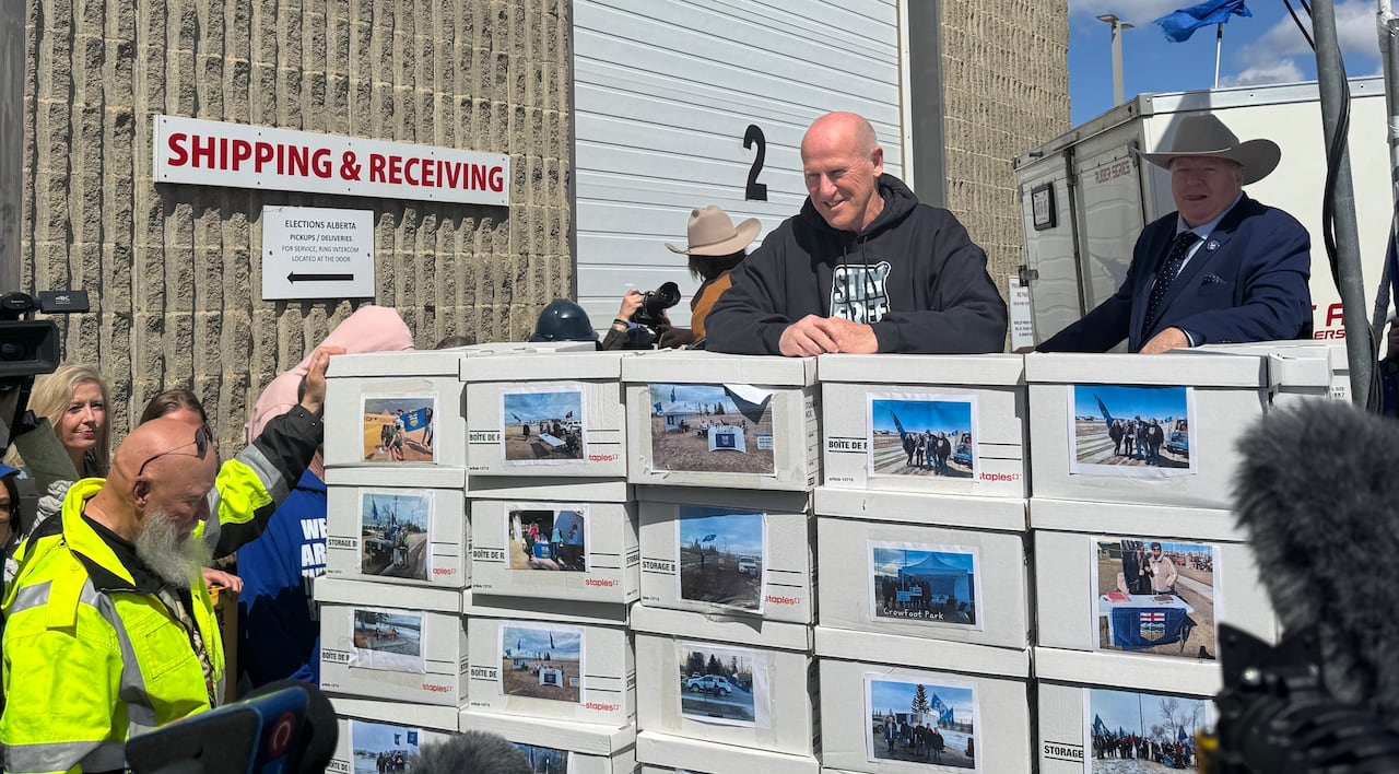 Man stands in front of stacks of legal boxes