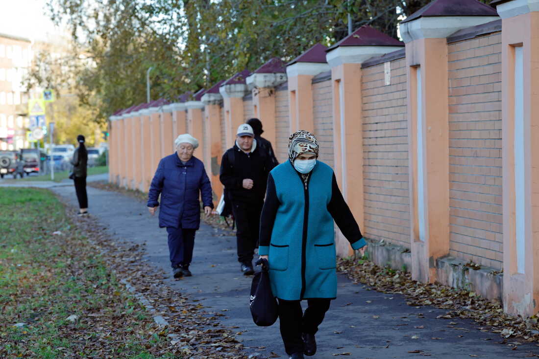 A woman wearing a face mask walks past the anti-plague institute in the city of Irkutsk on October 7, 2026.