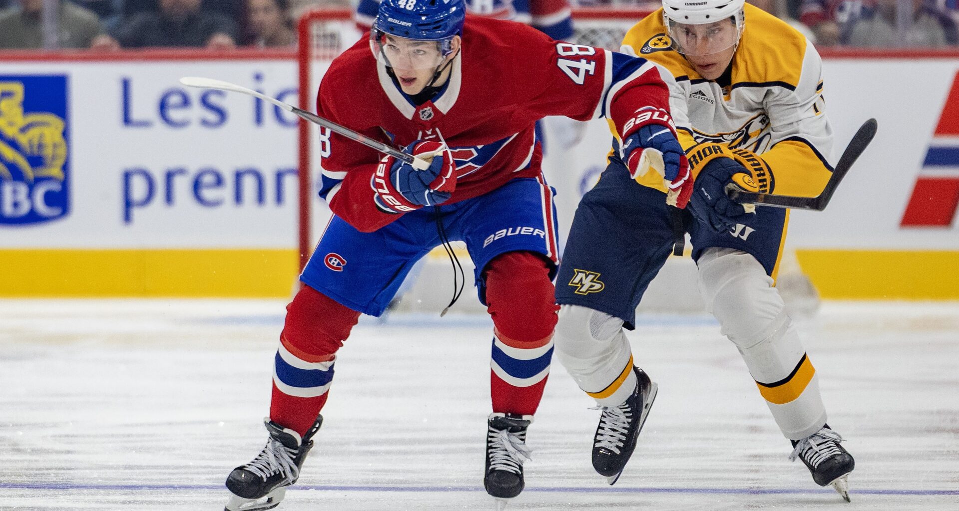 Canadiens defenceman Lane Hutson advances the puck while being pursued by Nashville Predators' Matthew Wood during first period in Montreal on Oct. 8.