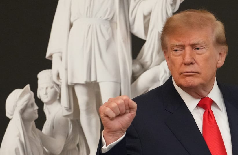 US President Donald Trump gestures at the end of a Columbus Day celebration in the East Room of the White House in Washington, DC, US, October 9, 2026. 
