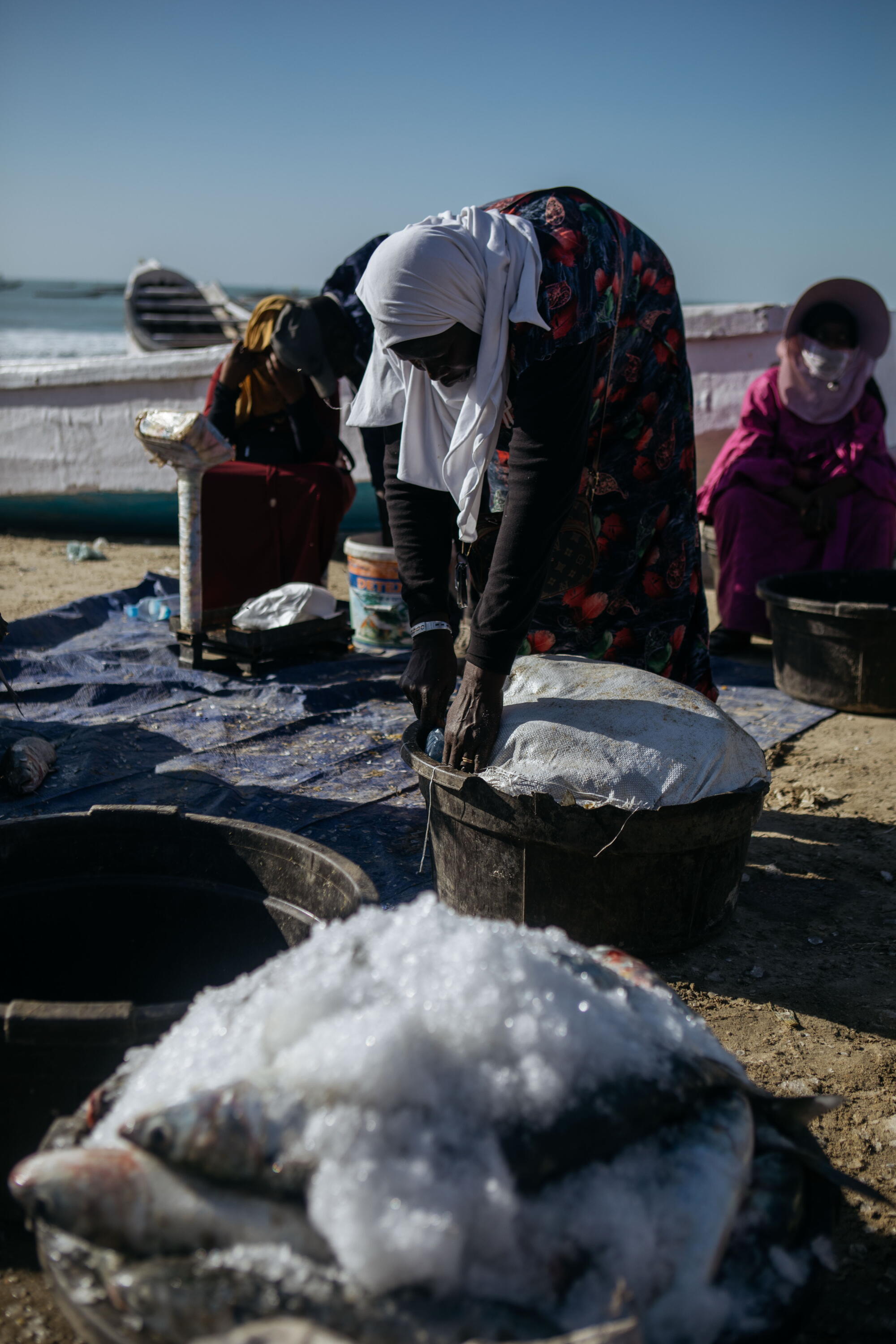 A women sells fish in Port de Pêche, a port in Nouakchott, the capital of Mauritania, on Feb. 7.