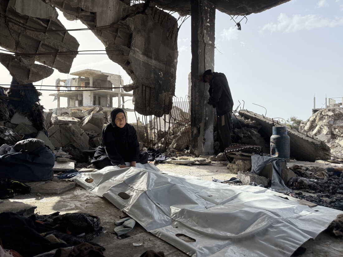 A mother from the Abu Nasr family sits by her son's body in Beit Lahia on February 17, 2026.
