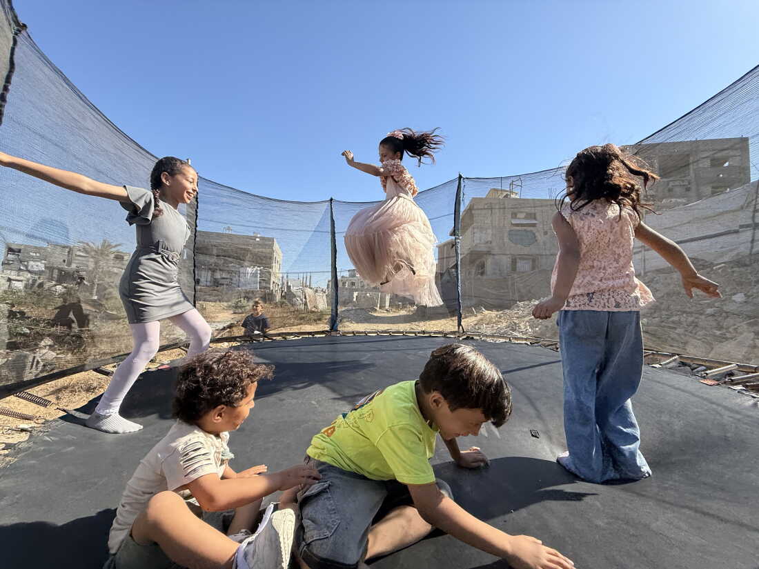 Children jump on a trampoline during the Eid holidays on May 31, 2026, in Beit Lahia.