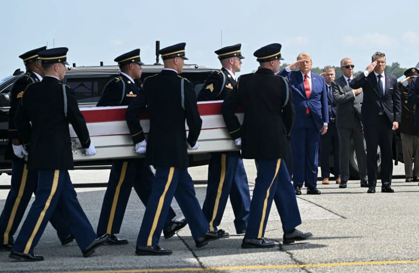 US President Donald Trump and Secretary of Defense Pete Hegseth salute as a US Army carry team carries the flag-draped transfer case containing remains during a dignified transfer event for US service members killed in the Middle East, at Dover Air Force Base in Dover, Delaware, on July 22, 2026. 
