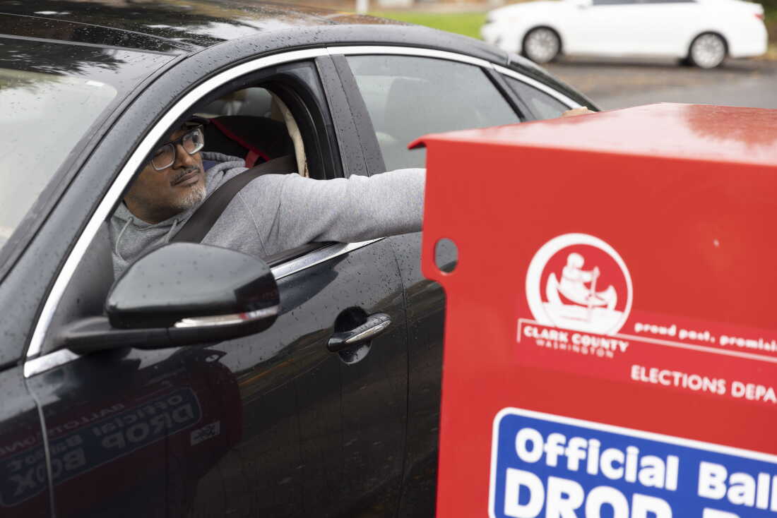 In this file photo, a voter drops his ballot in a ballot drop box in Vancouver, Wash., on Nov. 5, 2024.