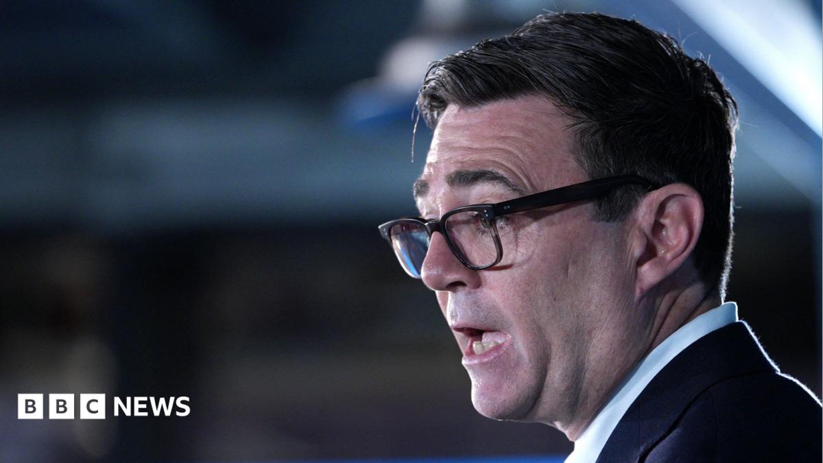 Close-up shot of Andy Burnham's face. The prime minister is wearing a dark suit jacket and light blue shirt.