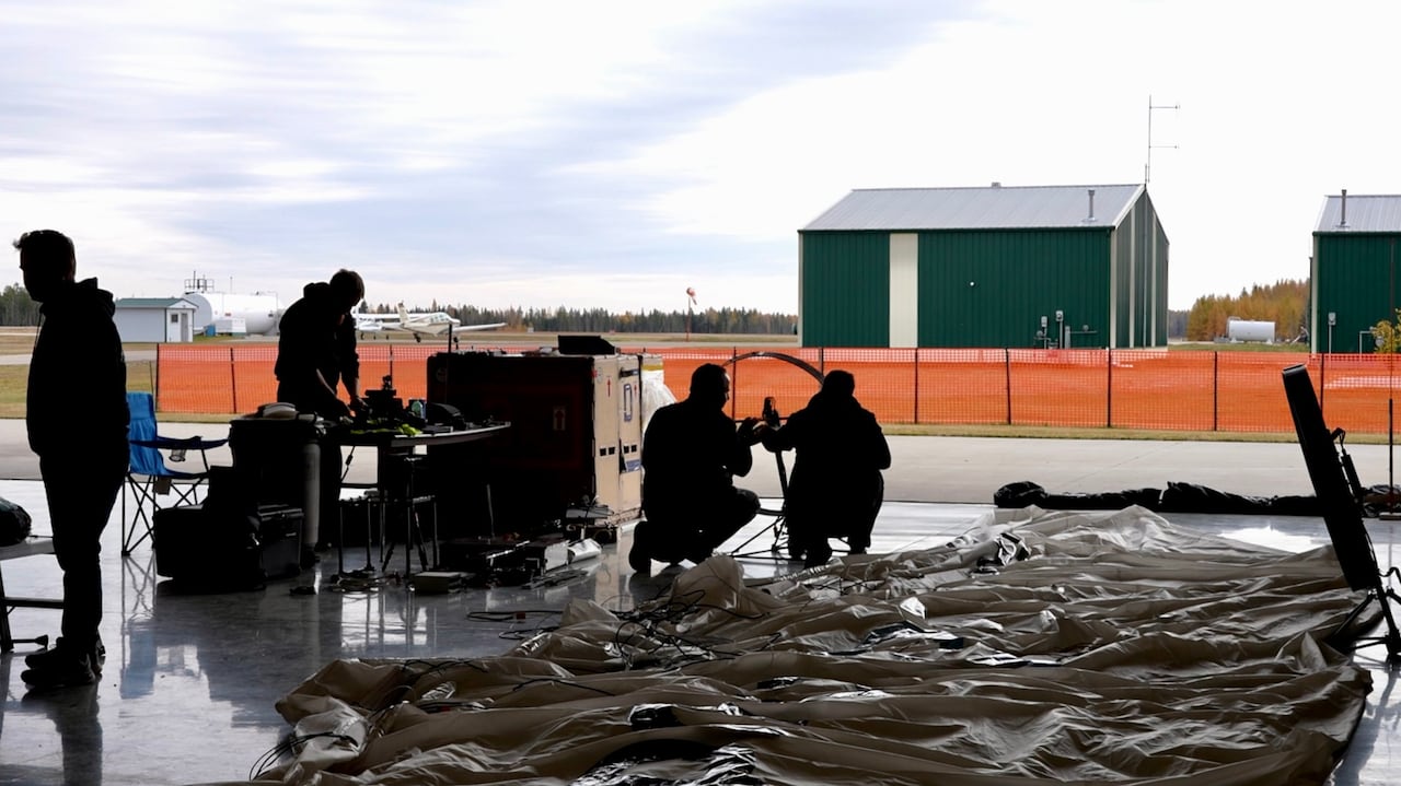 A flight crew working in a hanger.