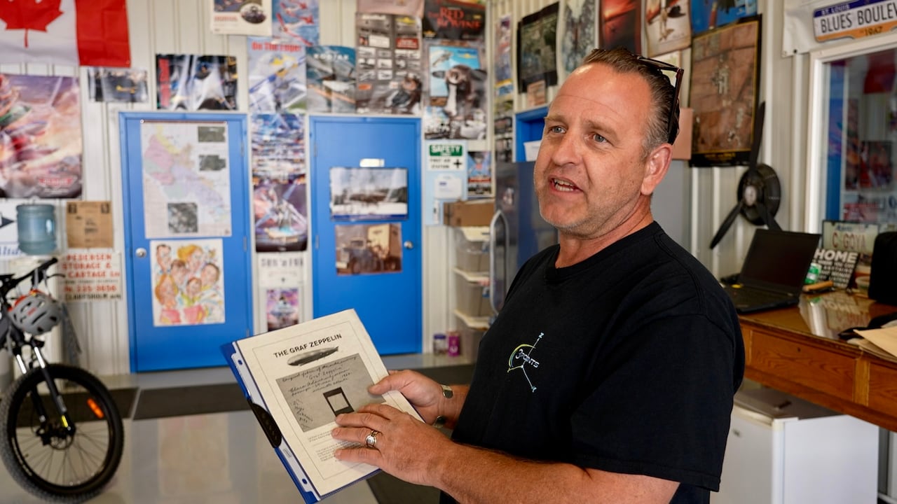 Man showing a file paper at a workshop.