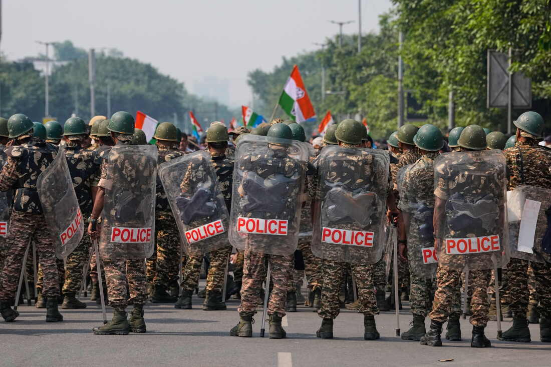 Security personnel in riot gear arrive to escort workers of India's opposition Congress party as they gather for a march toward the Supreme Court demanding the resignation of Chief Election Commissioner Gyanesh Kumar in New Delhi, India, on Monday.