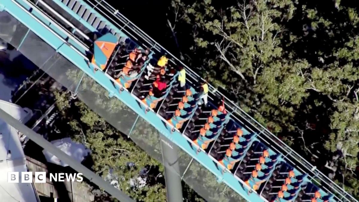 Riders are helped off a roller coaster at Six Flags in Georgia.