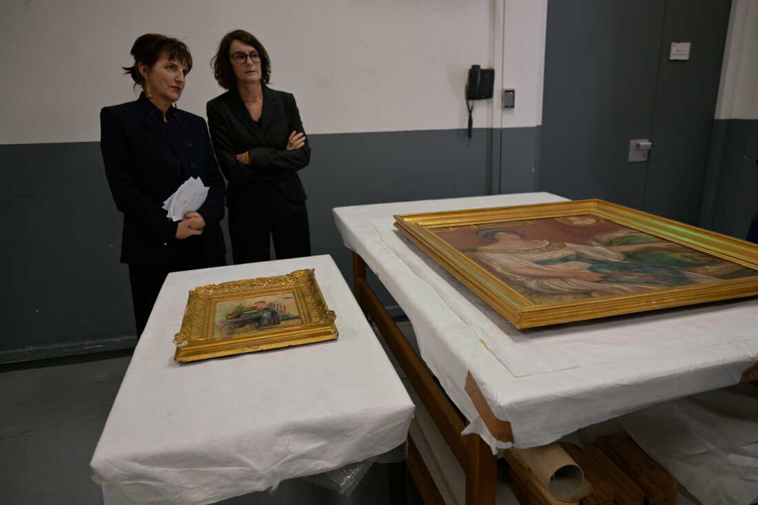 Recovered paintings "Portrait of Madame Colonna Romano" right, and "Young Woman at the Well," stolen from the Renoir Museum in Cagnes-sur-Mer are on display at the Interdisciplinary Centre for the Conservation and Restoration of Heritage in Marseille, France, Monday Oct. 12, 2026.