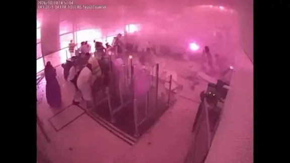 Surveillance footage shows smoke and fire as people react at the moment of an attack at King Khalid International Airport in Riyadh, Saudi Arabia, October 10, 2026, in this frame from a handout video. Saudi Ministry of Media