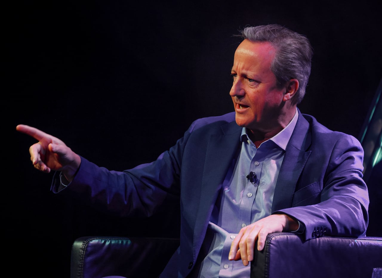 A man in a suit gestures.