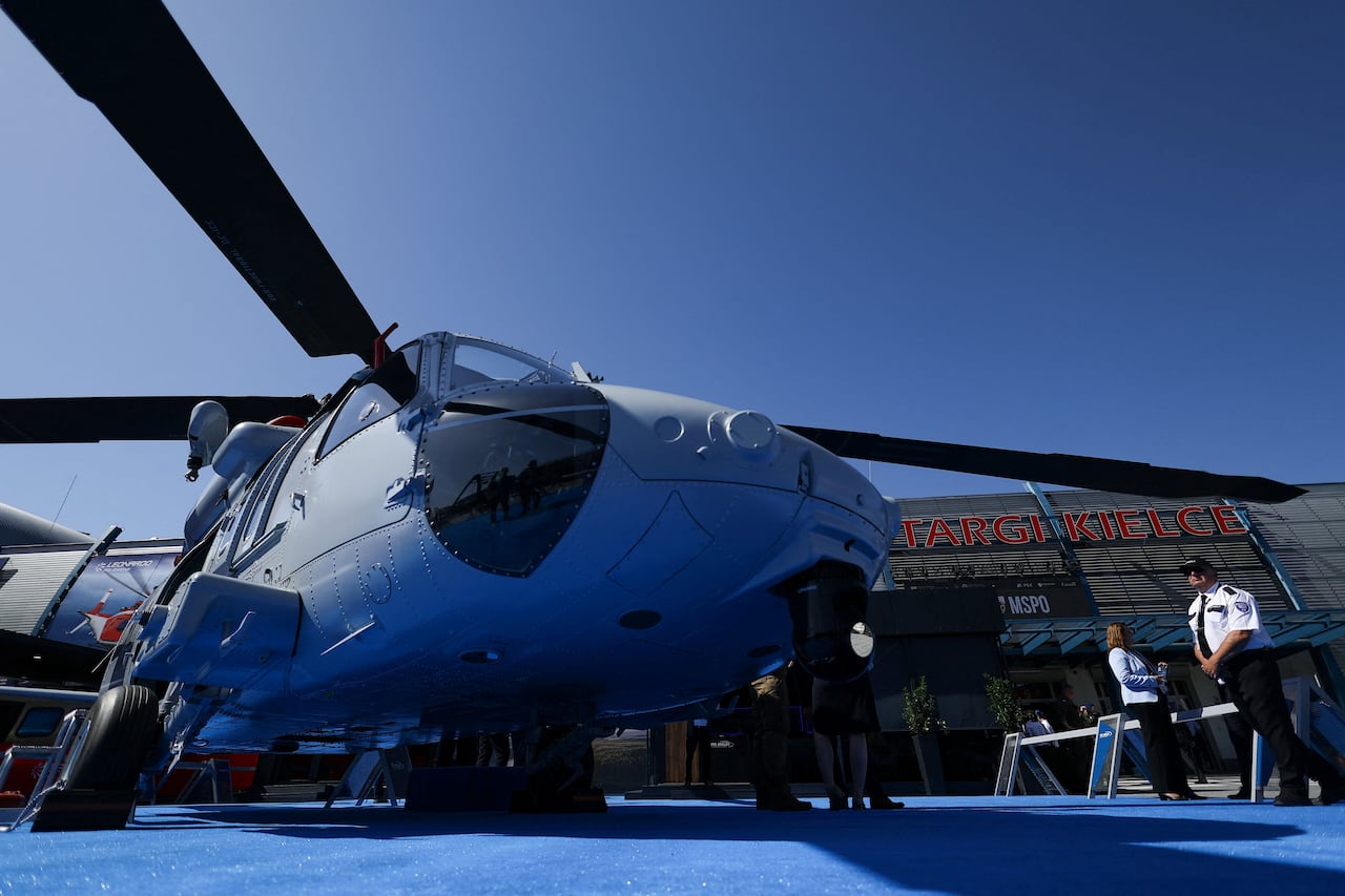A helicopter is seen from close up on land.