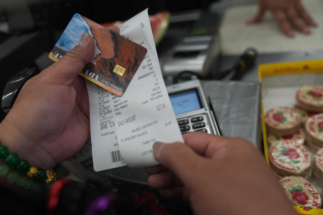 Jannette Victor checks her balance left after purchasing food supplies with a California EBT (Electronic Benefit Transfer) card in Los Angeles, Friday, Oct. 31, 2025. (AP Photo/Damian Dovarganes)