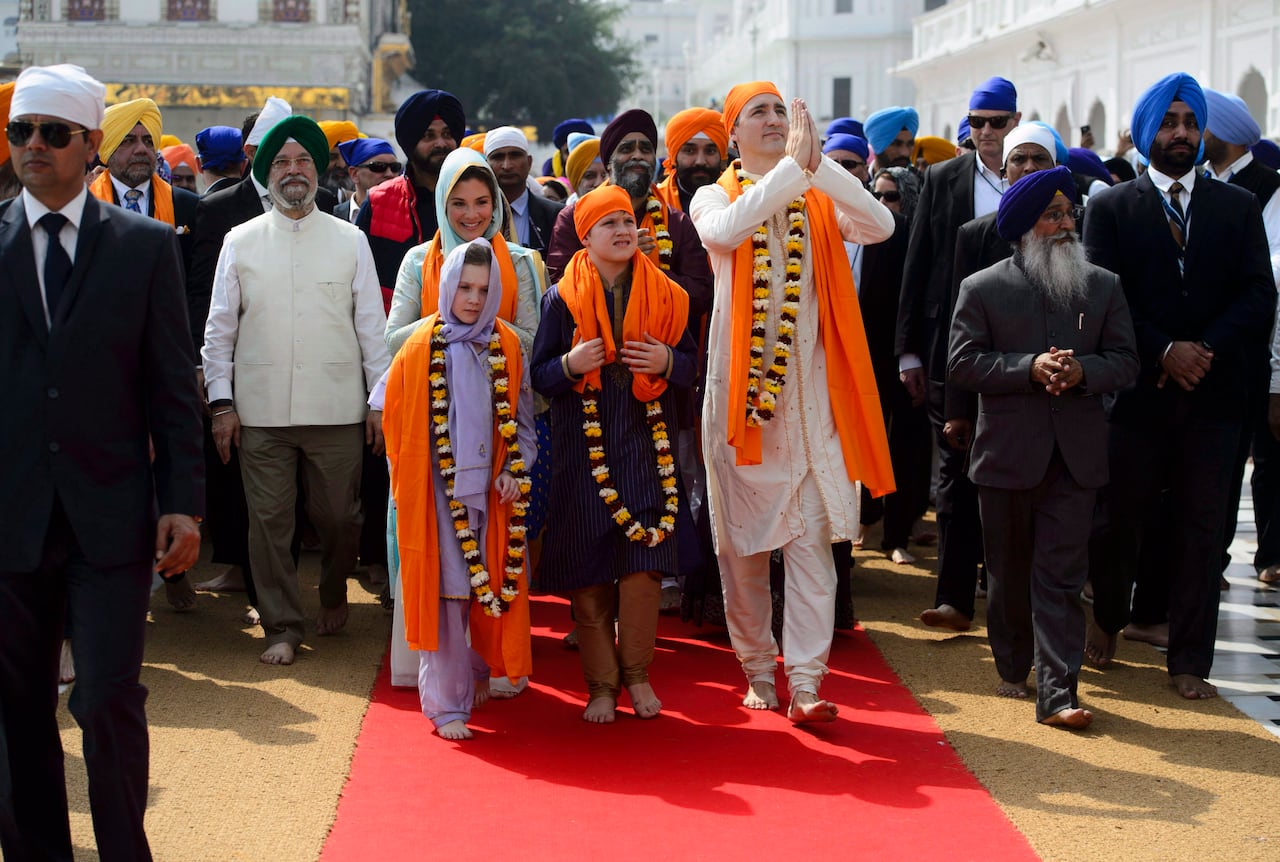 Then prime minister Justin Trudeau, his then wife Sophie Gregoire Trudeau and their children are shown barefoot wearing traditional Indian clothing.