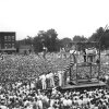 In this black-and-white photo, a huge crowd gathers around a wooden scaffold to witness the public hanging of Rainey Bethea in 1936 in Owensboro, Kentucky.