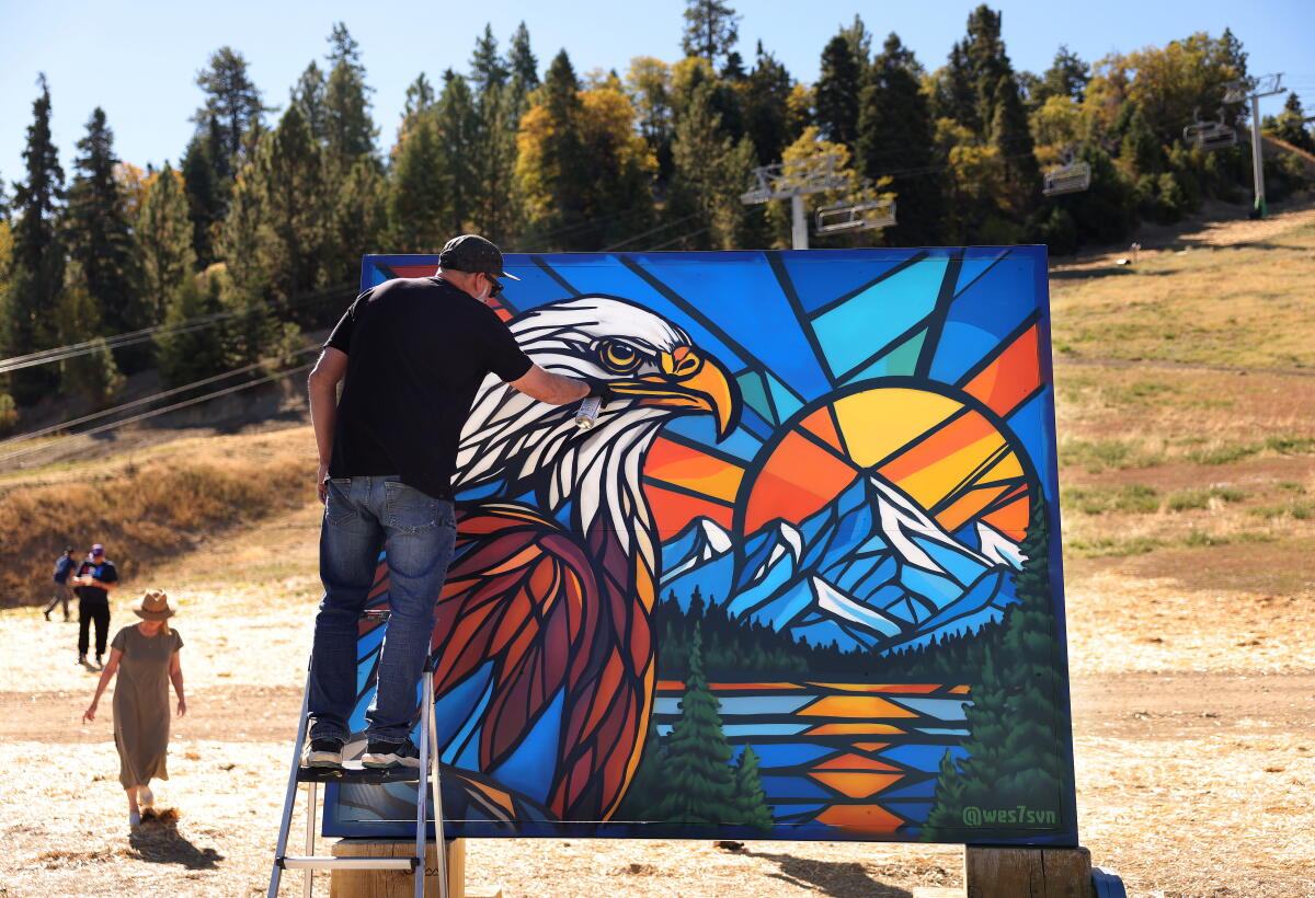 Muralist Wes Abarca works on an image of Jackie 
