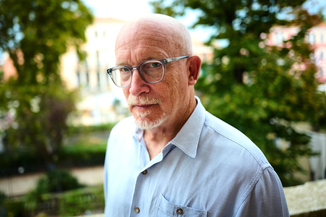 A man stands looking into the camera.