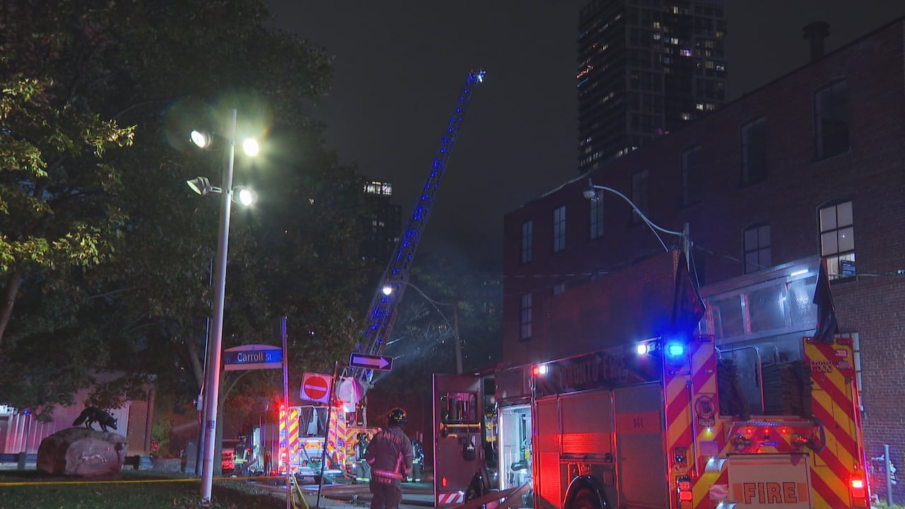 Firefighters use equipment to fight a fire