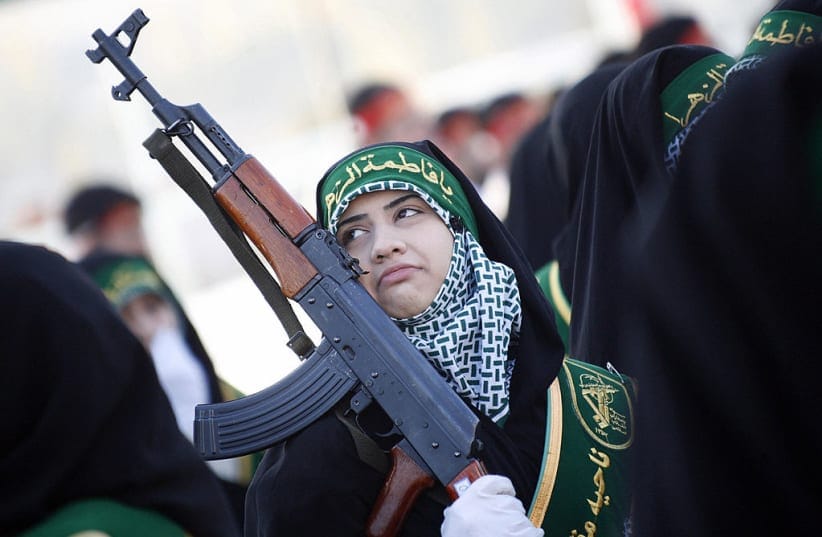 Illustrative: An Iranian woman member of the Basij militia's Ashura battalion takes part in a military parade to mark the national Basij week at a military base of Iran's elite Revolutionary Guards in northeastern Tehran on November 25, 2008.
