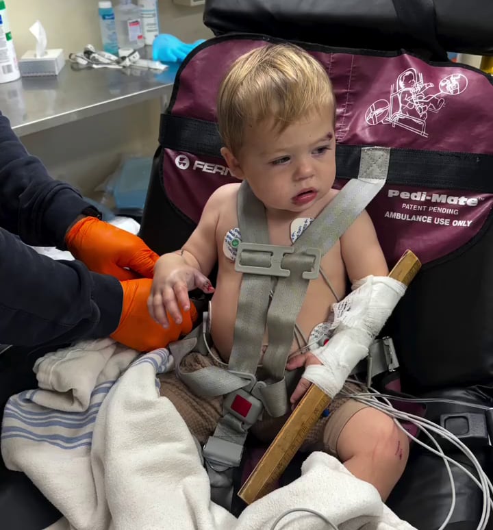 A boy in a chair in a hosptial being treated for a rattlesnake bite.