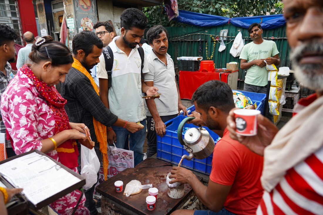 Vishnu Singh, 38, serves tea to patients, caregivers and others outside the hospital. Singh runs the stall with his brother, Arjun, and keeps it open 24 hours a day.