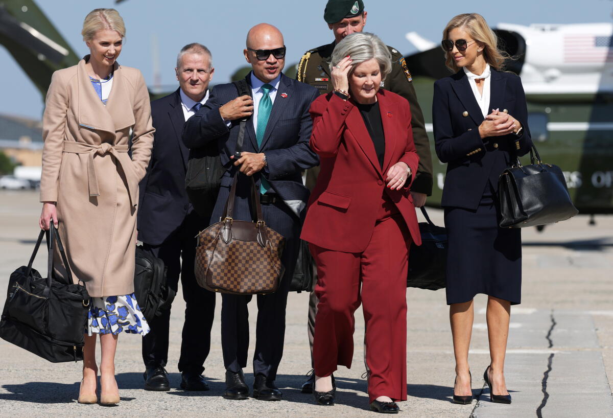 President Trump's senior aides walk to board Air Force One