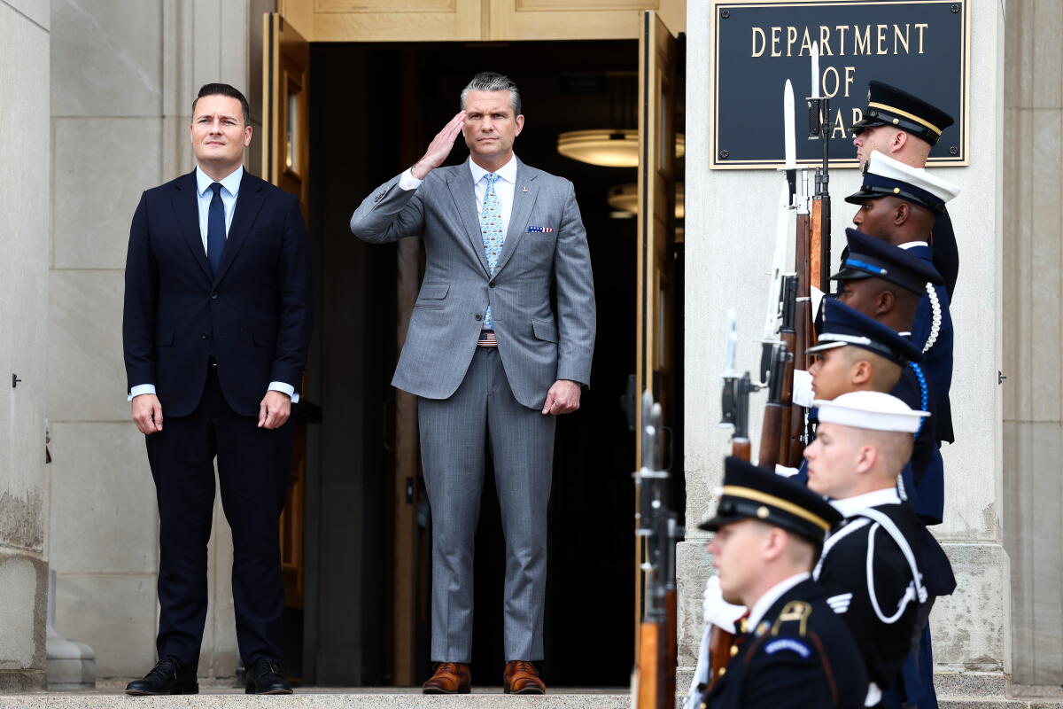 British Defense Secretary Wes Streeting stands next to a saluting Defense Secretary Pete Hegseth.