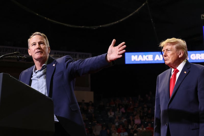 US Senator Jon Husted (R-OH) gestures while standing near US President Donald Trump during a campaign rally for Husted and gubernatorial candidate Vivek Ramaswamy in Youngstown, Ohio, US, October 12, 2026.