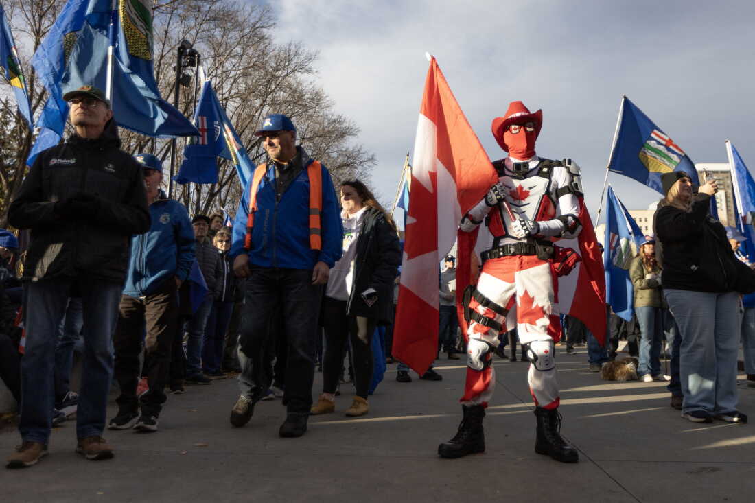 People cheer and wave flags at a rally hosted by Forever Canadian on Canadian Unity at the Edmonton Expo Center in Edmonton, Alberta, Canada on Oct.16, 2026.