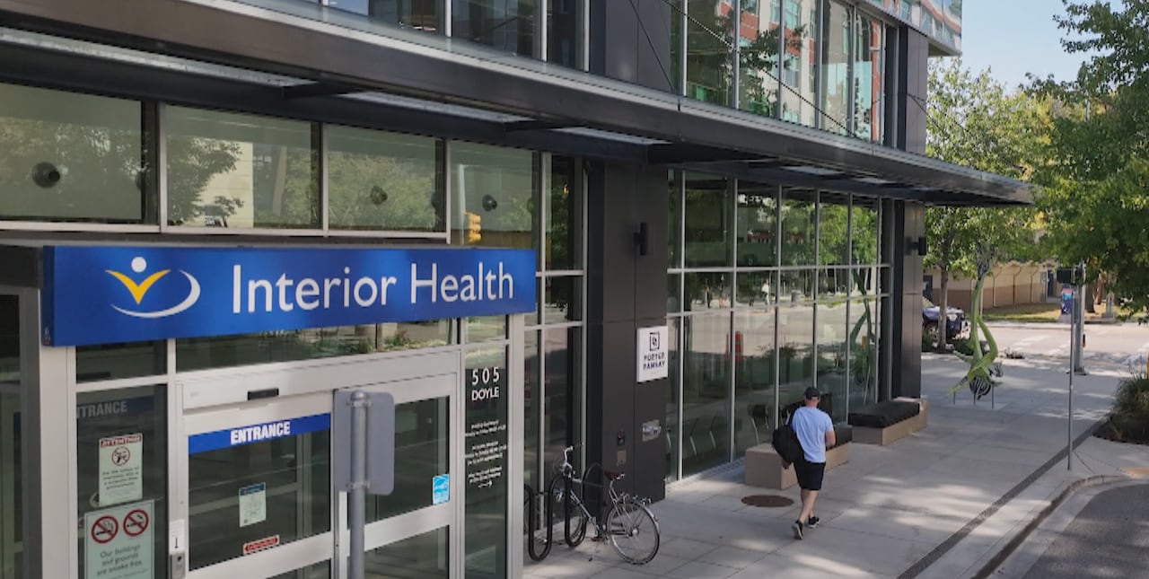 A building with glass windows and a sign which reads Interior Health