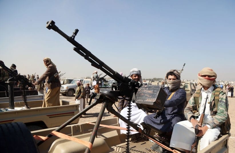 Houthi fighters man machine guns mounted on trucks as they participate in a weaponized protest staged against the US and Israel on November 6, 2025, in Sanaa.