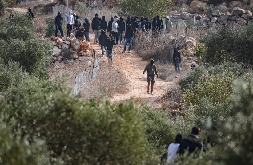 Masked extremist Jewish settlers clash with Palestinians during the annual olive harvest in the village of Abu Falah, near Ramallah in the West Bank, where several people, including American photojournalist Heidi Levine, were injured in an attack by Israeli settlers, October 16, 2026.
