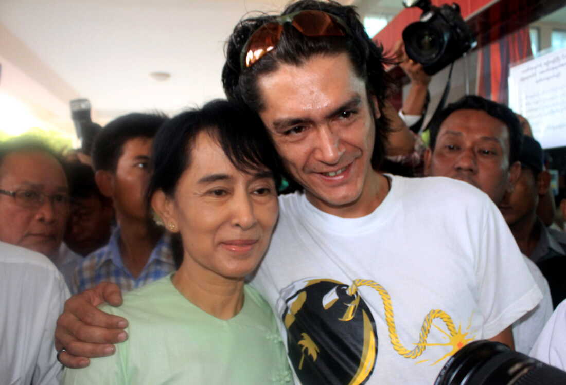 Myanmar's former leader Aung San Suu Kyi and her son Kim Aris pose for a photo at Bagan airport before leaving for Yangon, Myanmar, on July 8, 2011.