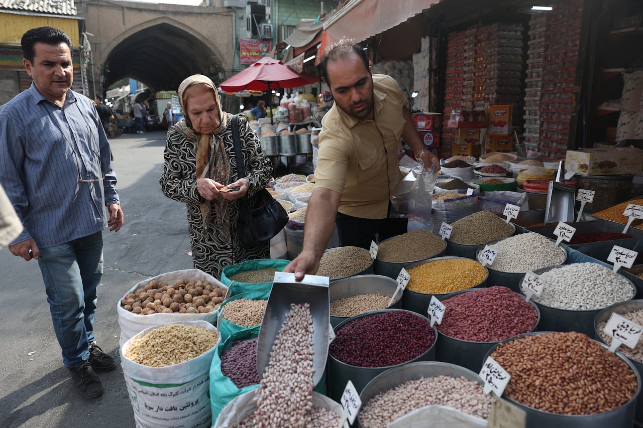 A shopkeeper works at his shop in a local market in Tehran, Iran, September 26, 2026.