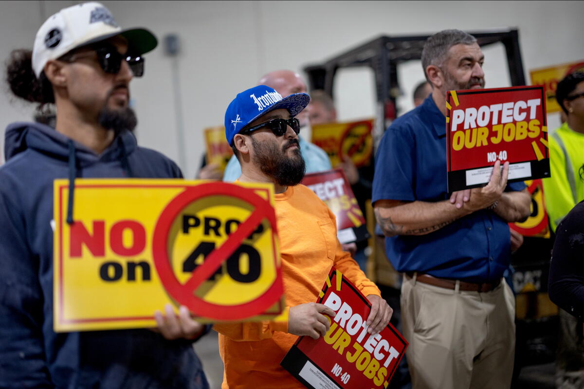People attend a rally against Proposition 40 at the Iron Workers Apprenticeship Training Center