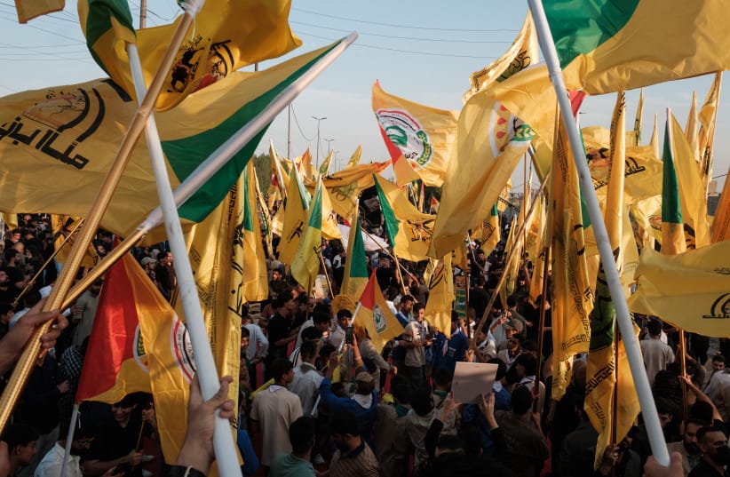 Supporters of the Popular Mobilisation Forces (PMF) chant slogans and wave flags at a rally celebrating the end of the U.S. military presence in Iraq on September 30, 2026 in Baghdad, Iraq.