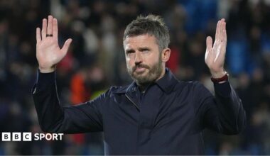 Manchester United manager Michael Carrick making a gesture of apology to fans