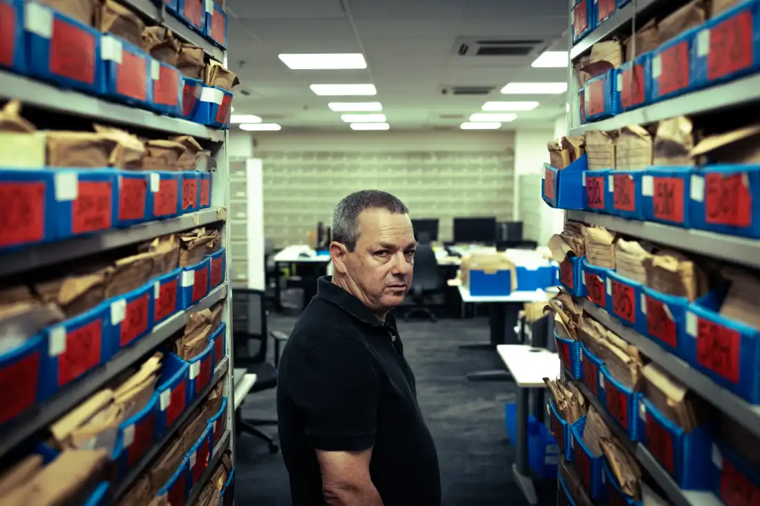Amos Harel, defense analyst for the Israeli daily Haaretz, stands inside the newspaper's archival library in Tel Aviv.