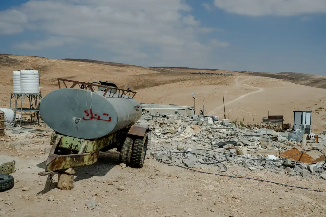 Rubble and concrete debris from the demolished home of Yaser Abu Sabha lie scattered beside a water tank trailer in Masafer Yatta, in the Israeli-occupied West Bank, on Sept. 24, 2026.