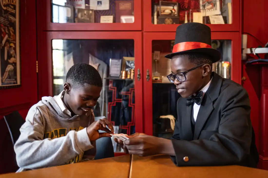 Themba Van der Westhuizen, 12, practices a magic trick on a school mate at the College of Magic in Cape Town, South Africa. Van der Westhuizen says he enjoys being able to impress his friends and family with his tricks. He also says learning to become a performing magician has transformed his self confidence.