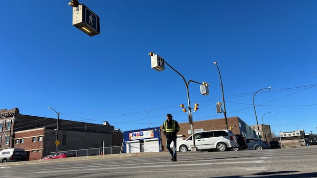 Pedestrian dies after being struck by vehicle at crosswalk