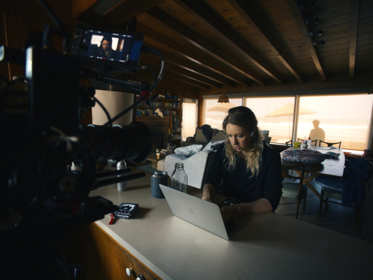A woman works on a laptop.