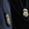 The badges of Immigration and Customs Enforcement (ICE) agents are seen as they patrol the halls of immigration court at the Ted Weiss Federal Building in New York City.