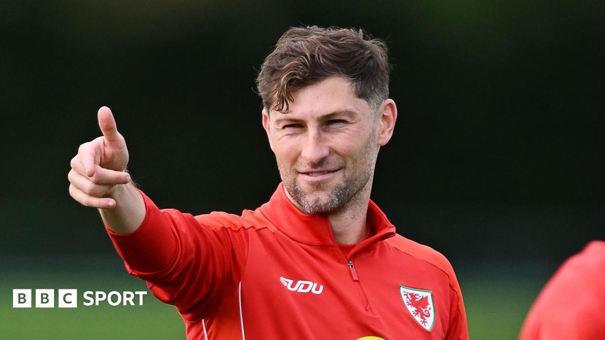 Ben Davies points during Wales training