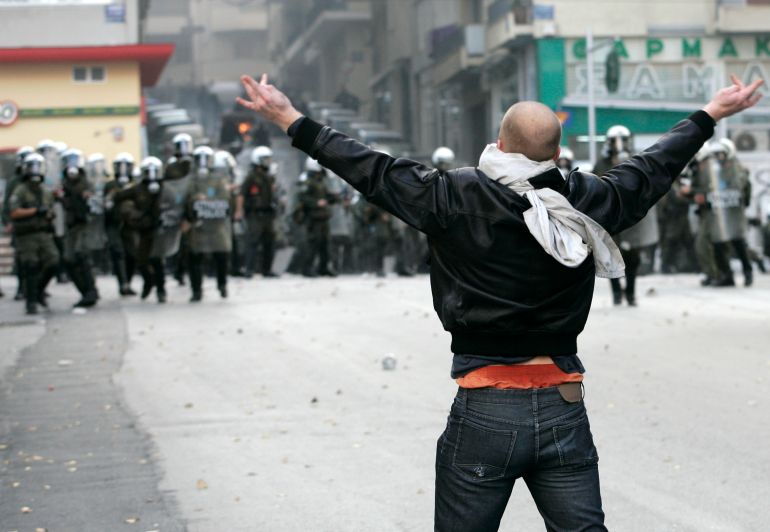 A protester confronts riot police in Athens, December 7, 2008